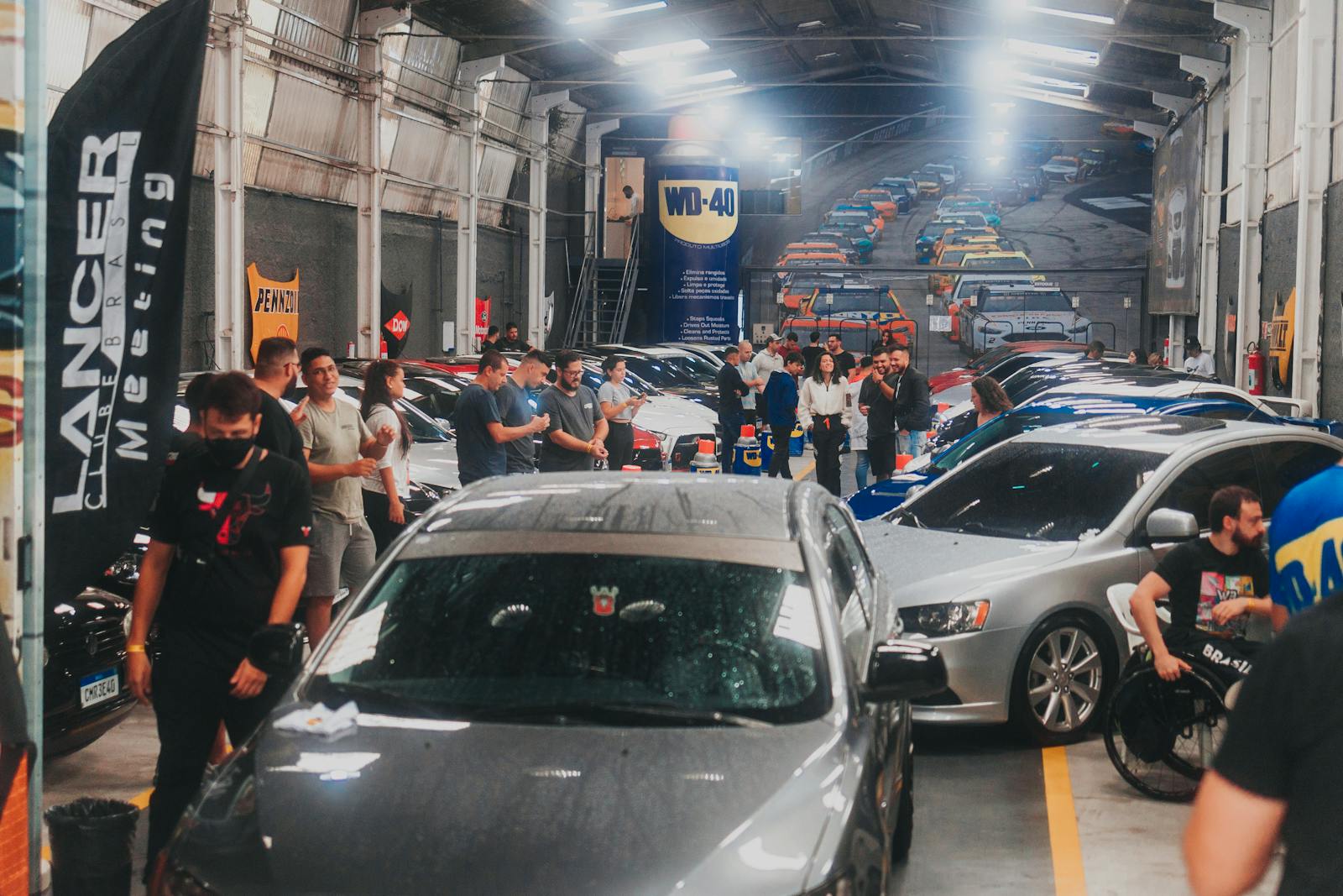 Cars gathered at a club meet under lights